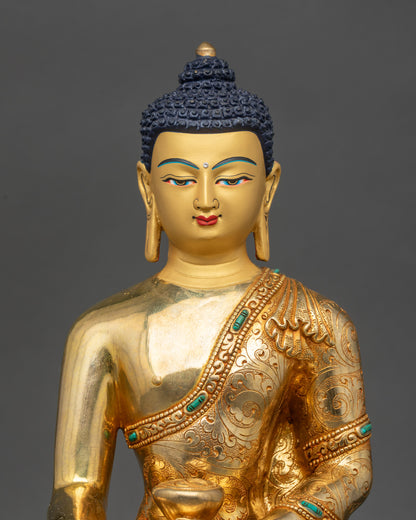 Close-up of Shakyamuni Buddha face, gold-painted serene expression, handcrafted in Patan, Nepal