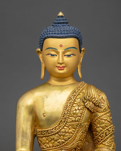 Close-up of Shakyamuni Buddha face showing tranquil expression and gold-painted features