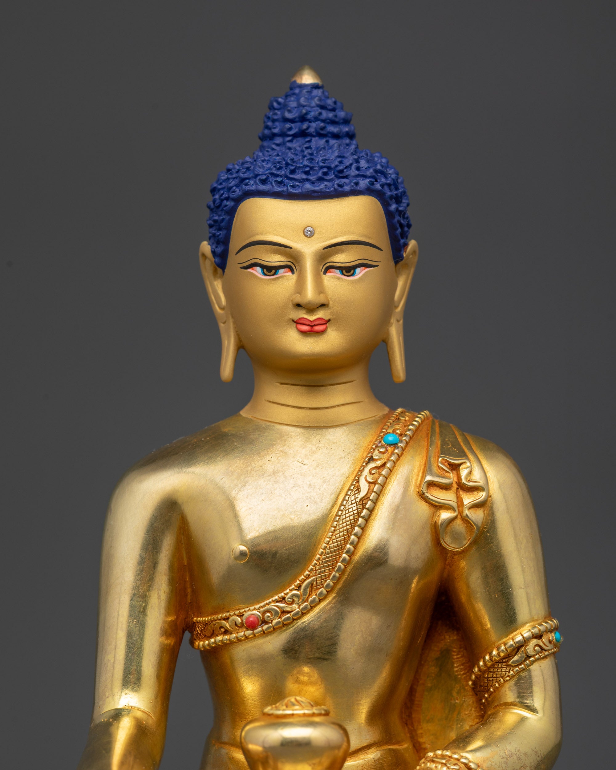 Close-up of Shakyamuni Buddha face with serene expression and semi-precious stones