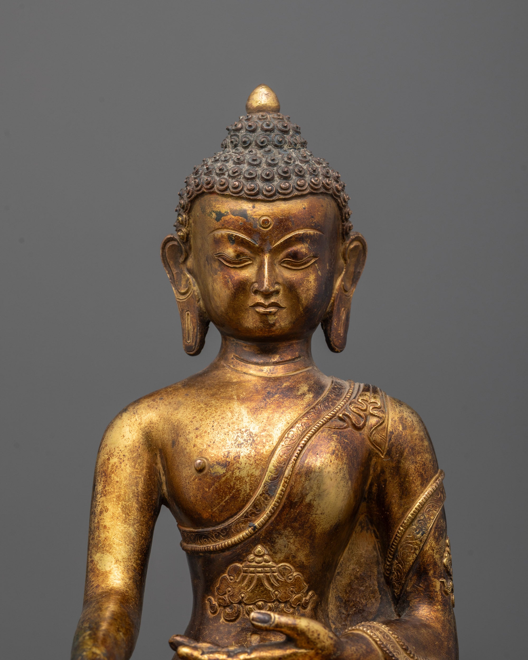 Close-up of Shakyamuni Buddha’s Peaceful Face with Intricate Gold Detailing