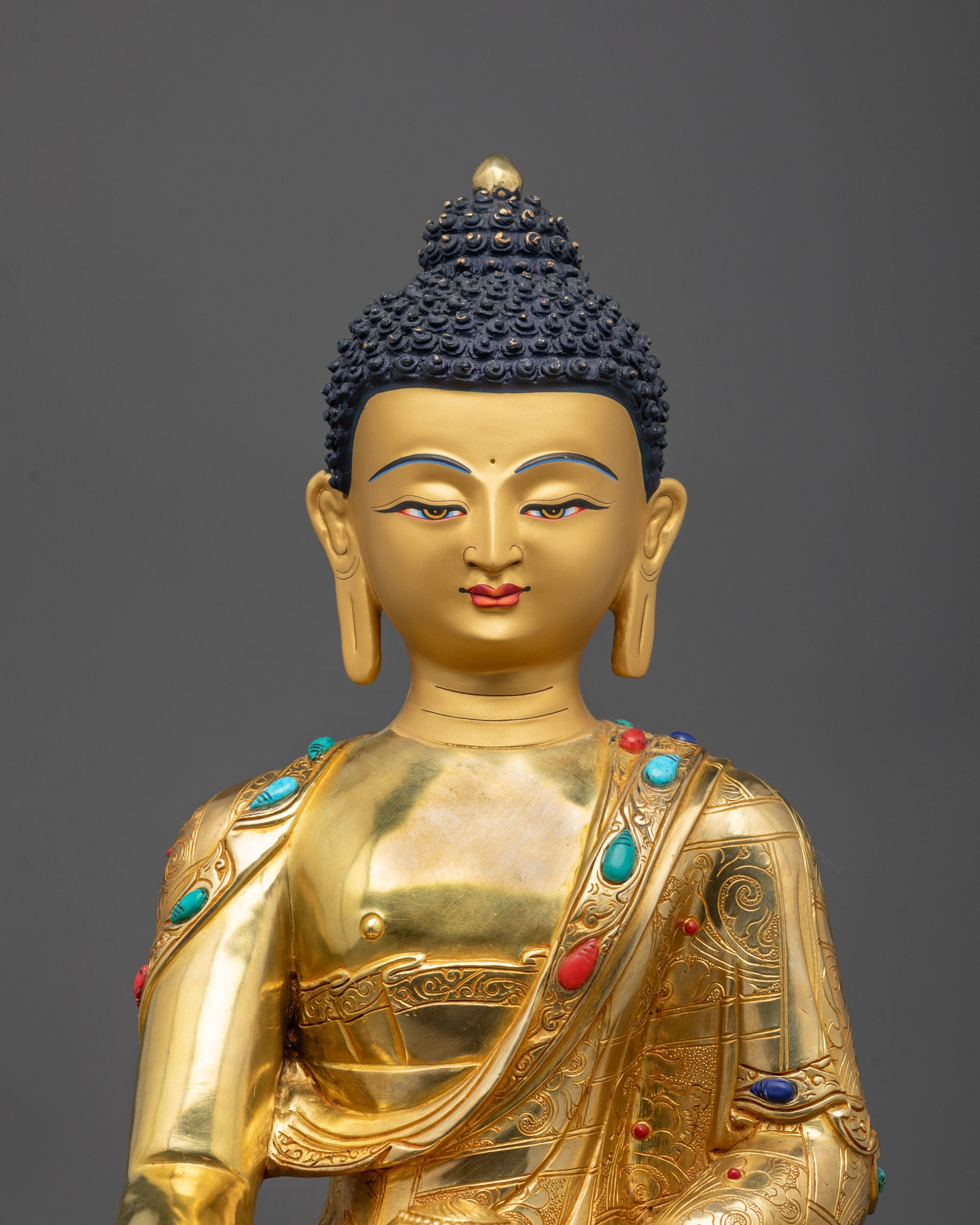 Close-up of Shakyamuni Buddha’s face polished and gilded with 24k fire gold