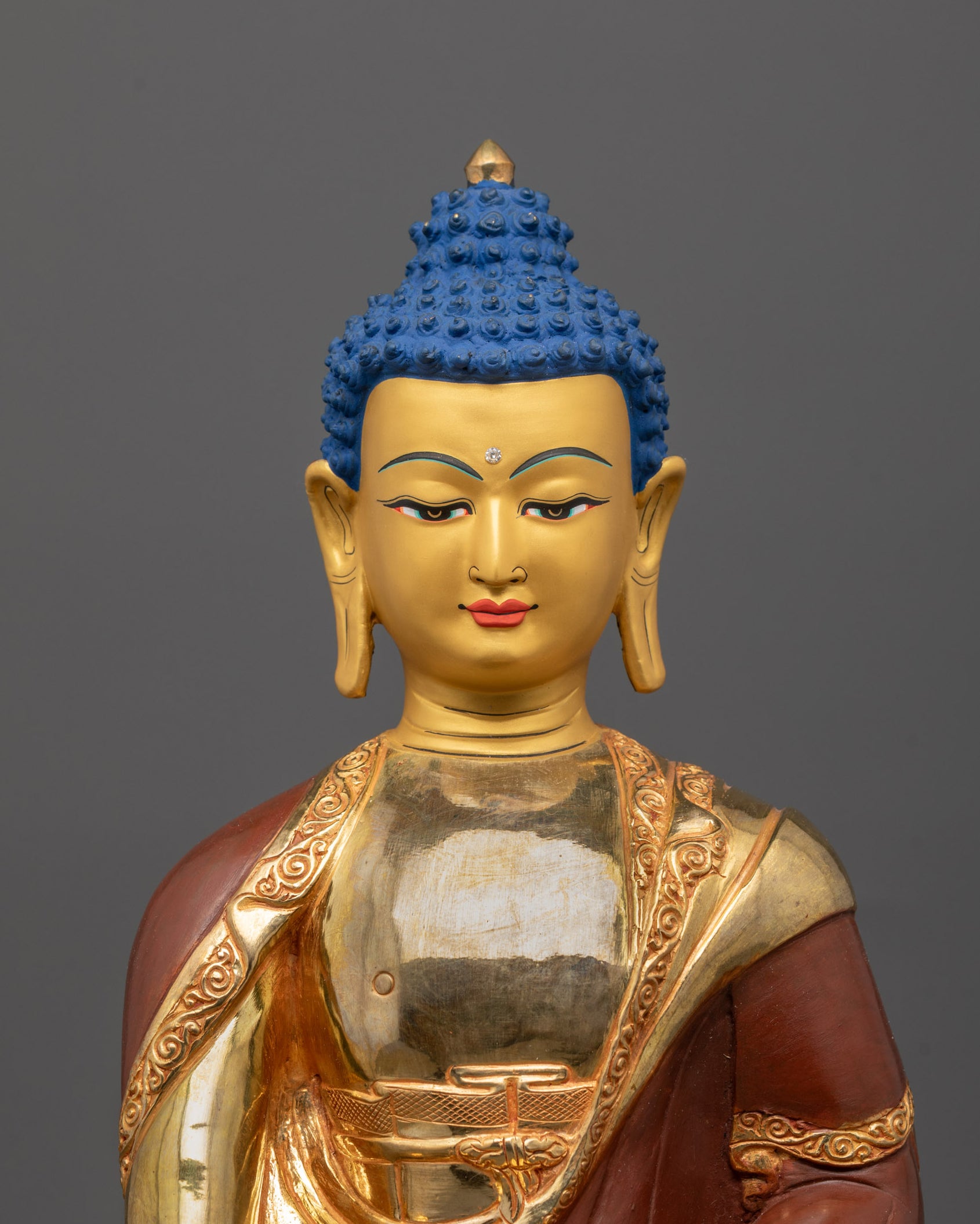 Close-up of Shakyamuni Buddha's gold-gilded face with serene expression