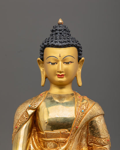 Shakyamuni Buddha’s serene face adorned with vibrant semi-precious stones and detailed 24k gold gilding on oxidized copper.