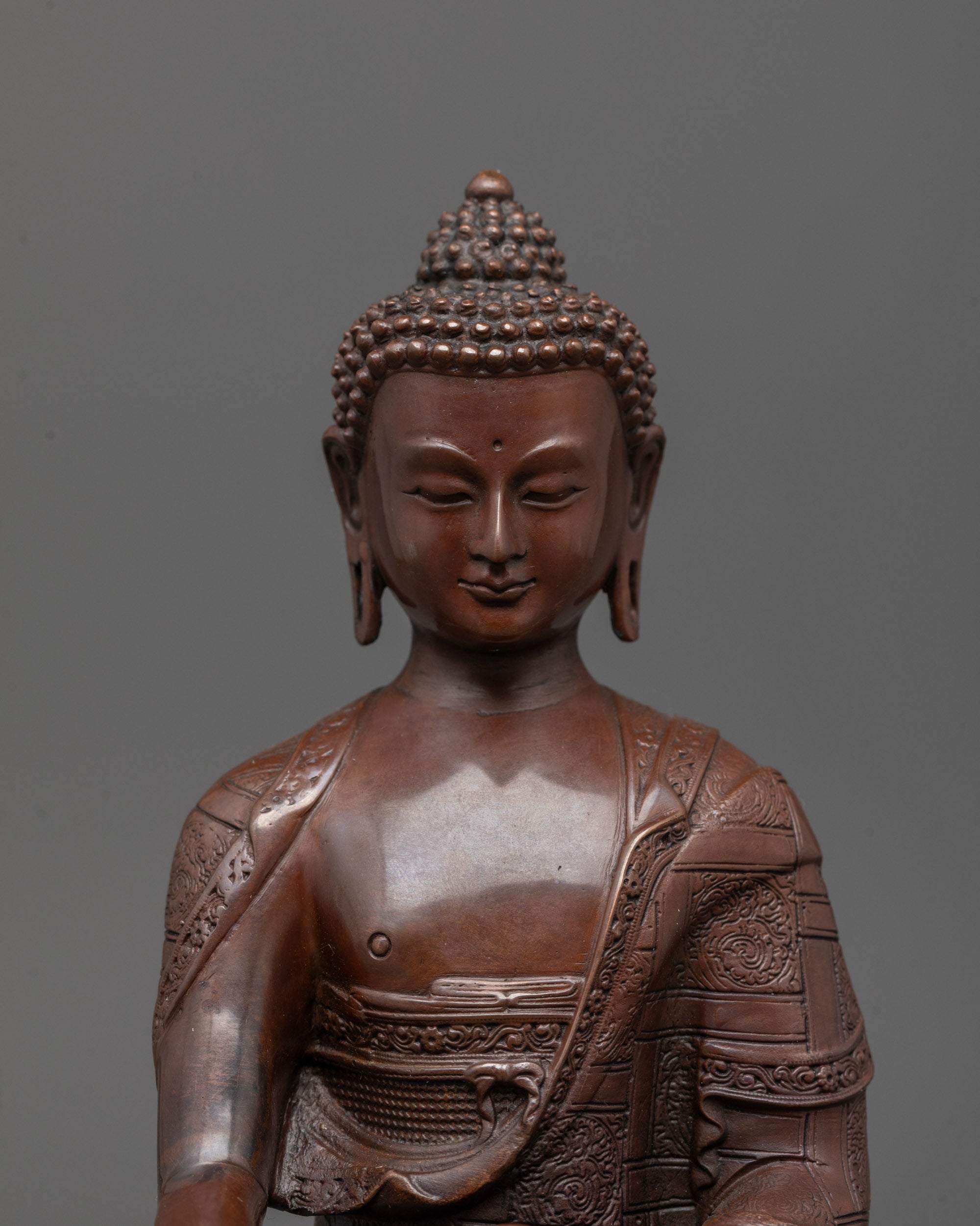 Close-up of Shakyamuni Buddha’s serene face and detailed hand gestures
