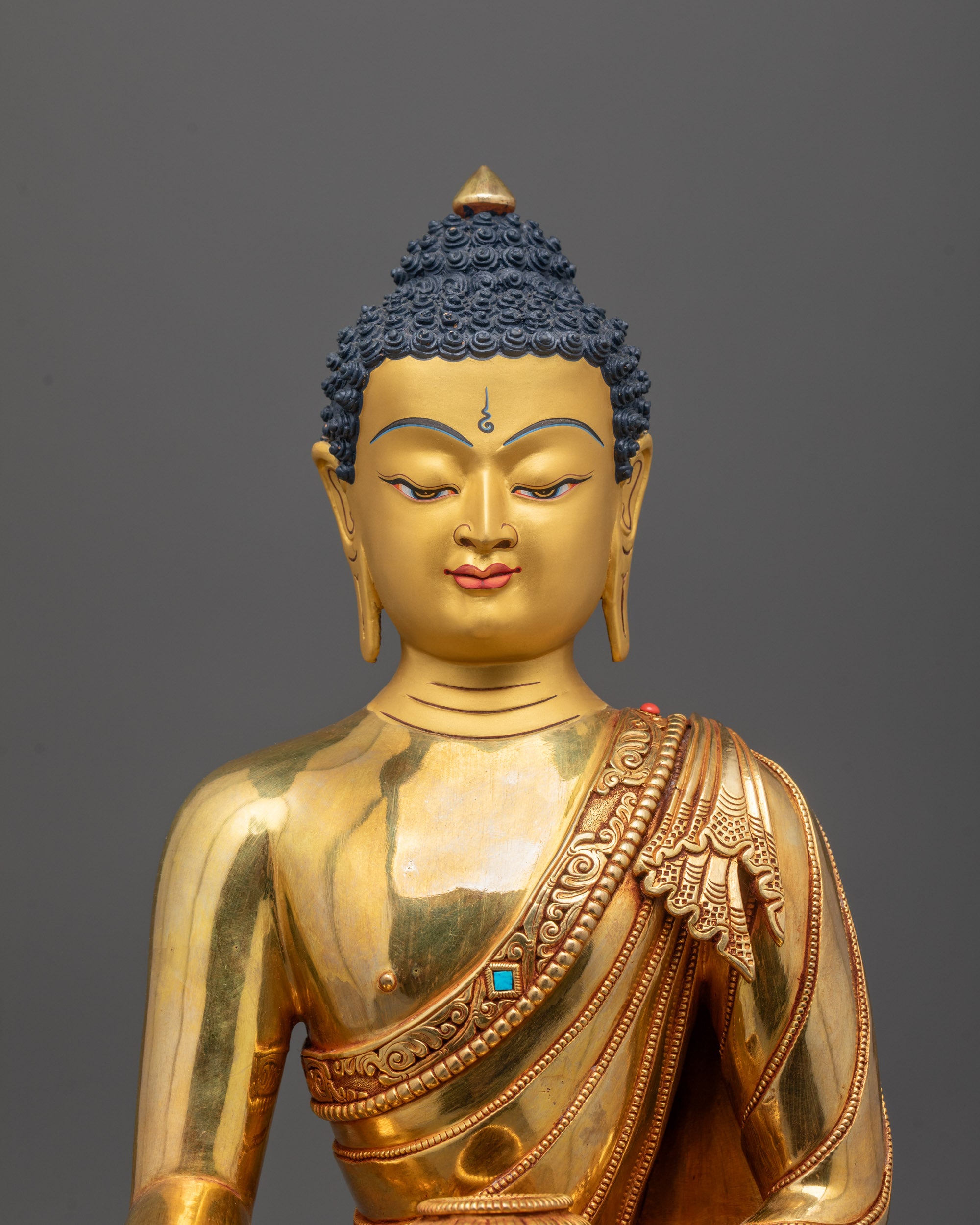 Close-up of Shakyamuni Buddha’s serene face gilded in 24k fire gold with fine copper