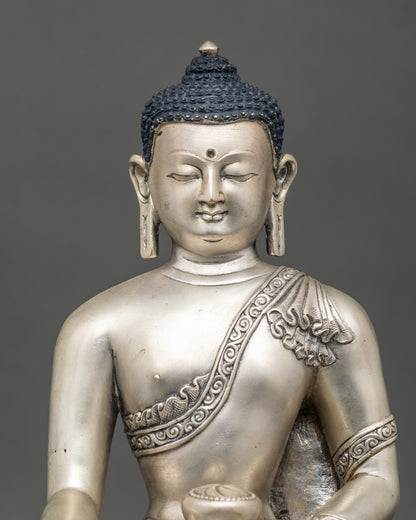 Close-up of Shakyamuni Buddha sculpture showing intricate lost-wax artisan details