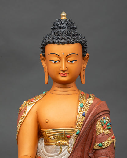 Close-up of Shakyamuni Buddha statue showing gold fire-gilding and serene posture