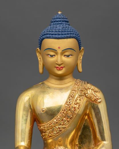 Close-up of Shakyamuni Buddha statue showing gold gilding and intricate robe details