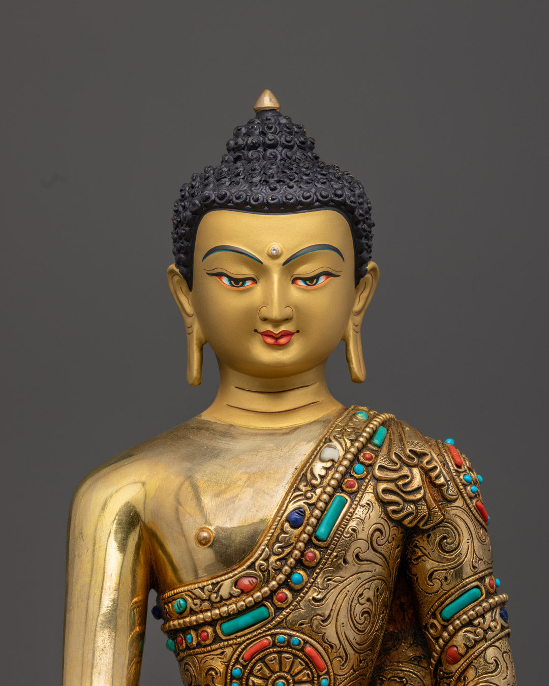 Shakyamuni Buddha statue showing intricate hand-carved details and vibrant acrylic colors with hollow mantra chamber