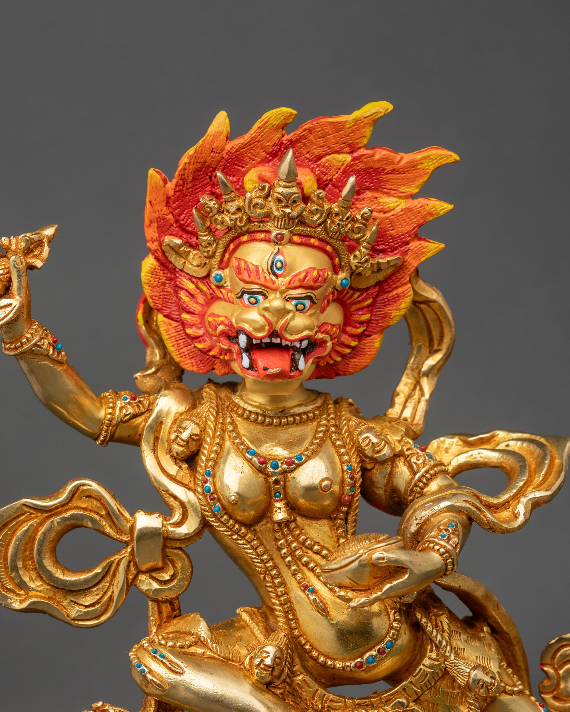 Close-up of Simha Mukha statue showing gold-painted face and intricate Newari artisan details
