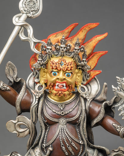 Close-up of TaklaMebar statue subduing two human figures, intricate Himalayan detailing