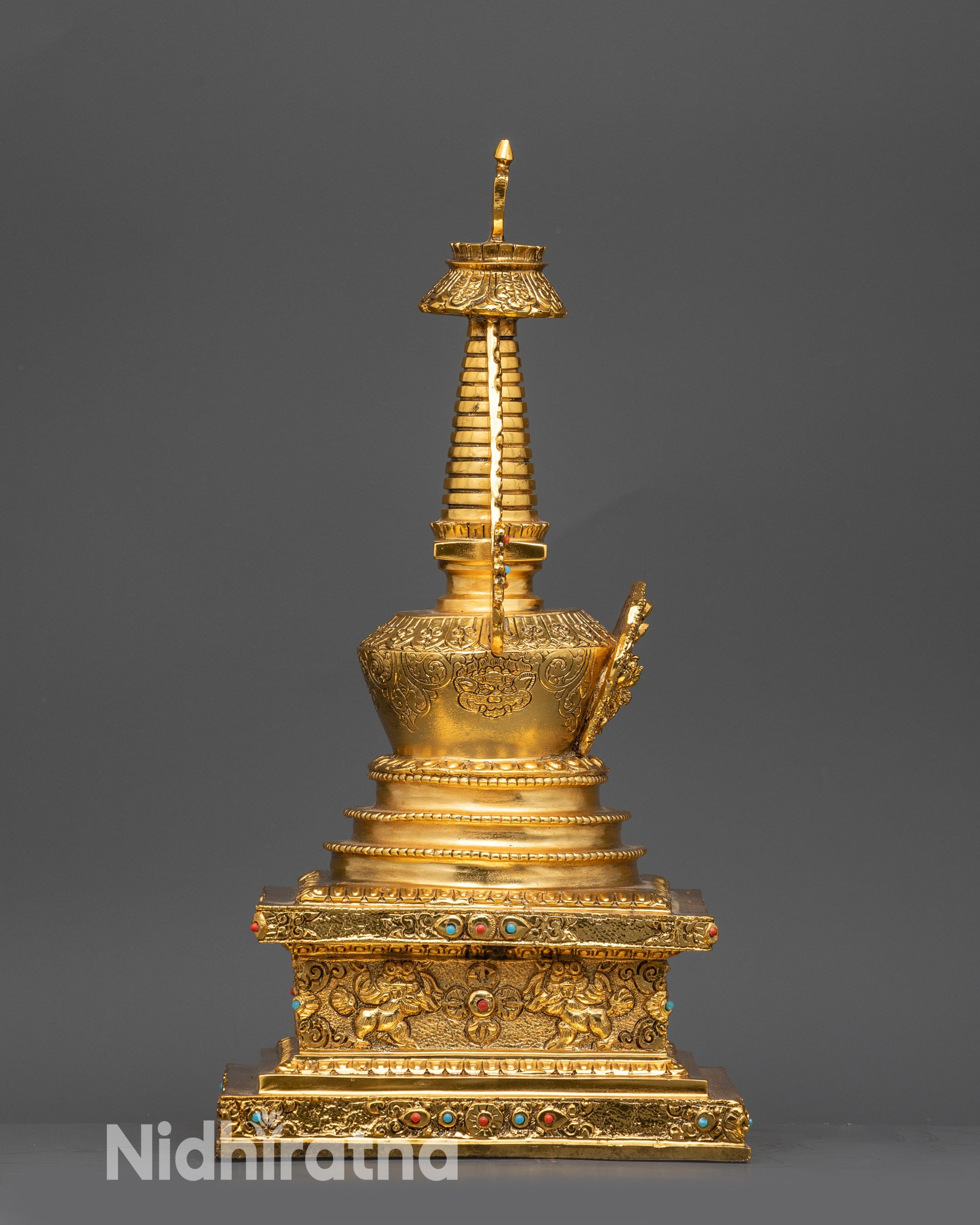 Close-up of Tibetan Namgyal Stupa showing Ushnishavijaya figurine and stone details