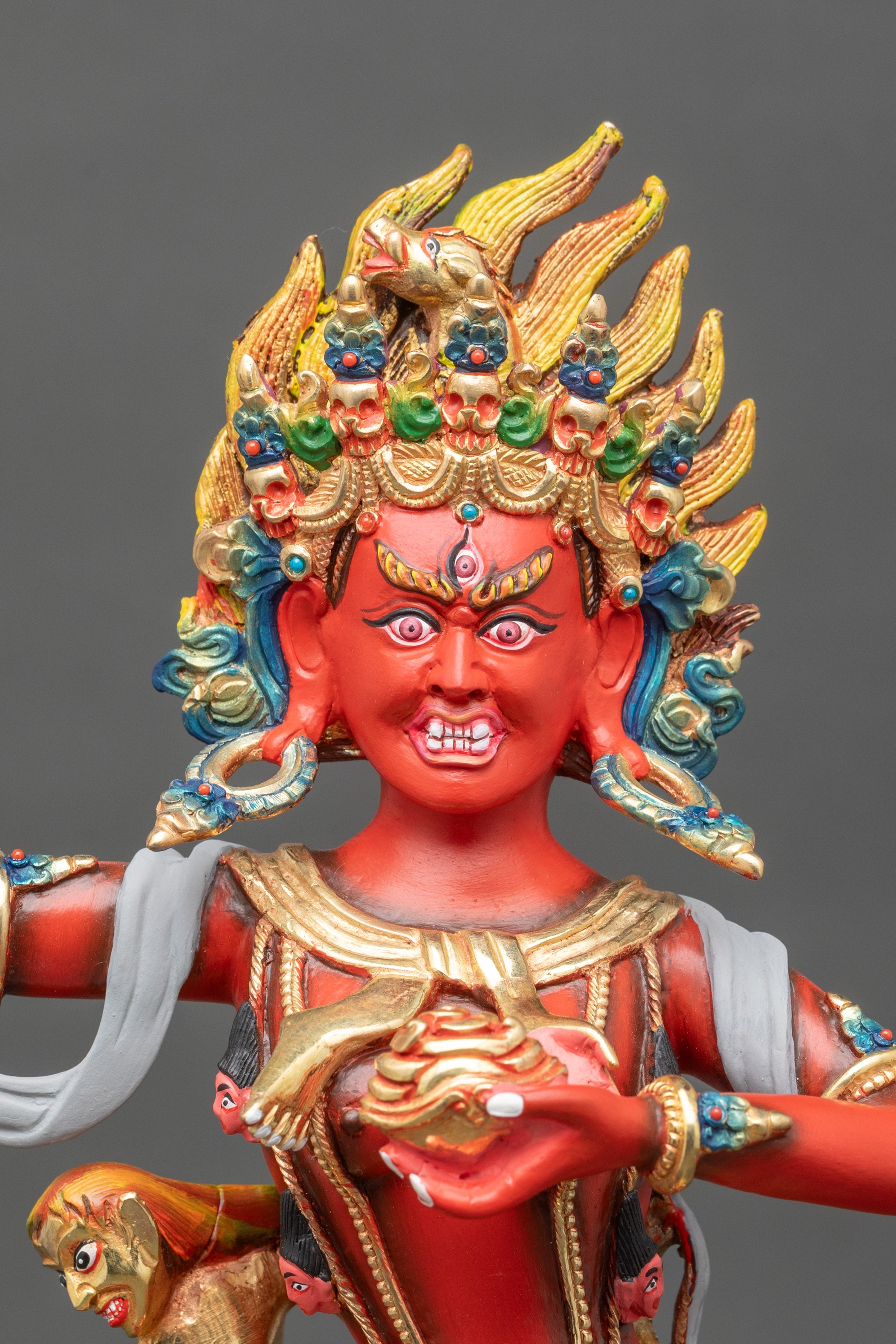 Close-up of Troma Nagmo statue, copper body and detailed painted features