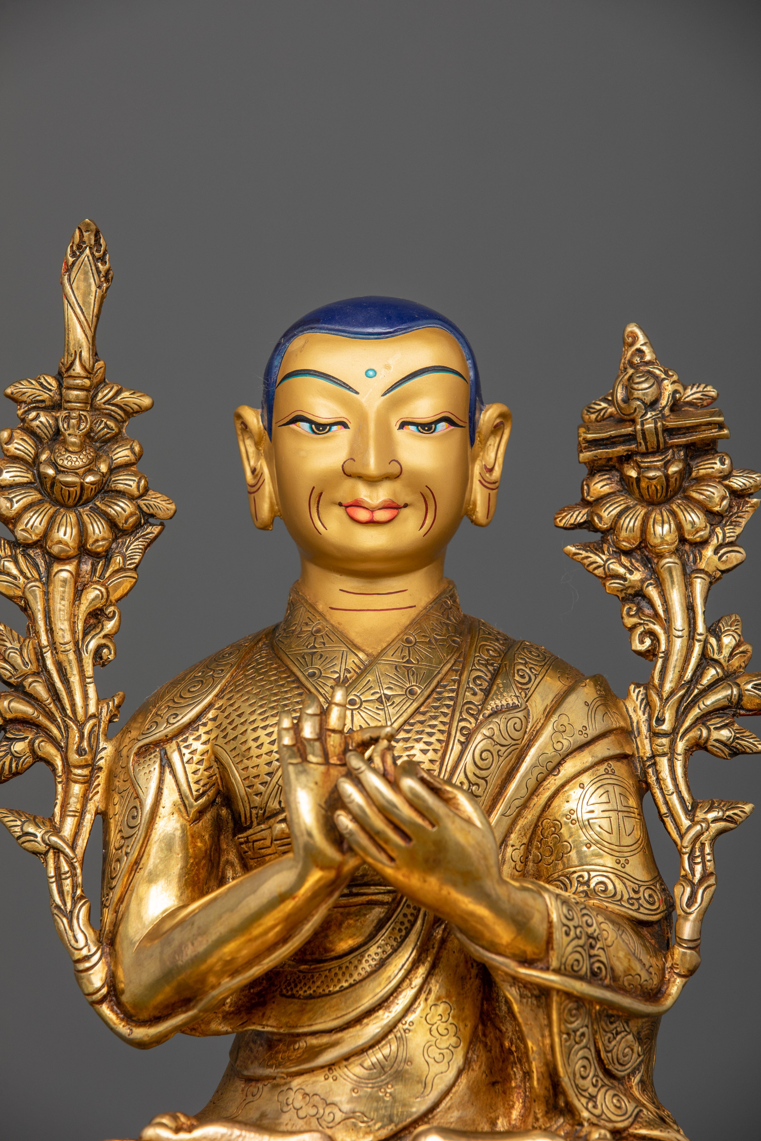 Close-up of Tsongkhapa Triad gold fire-gilded face and intricate robe details