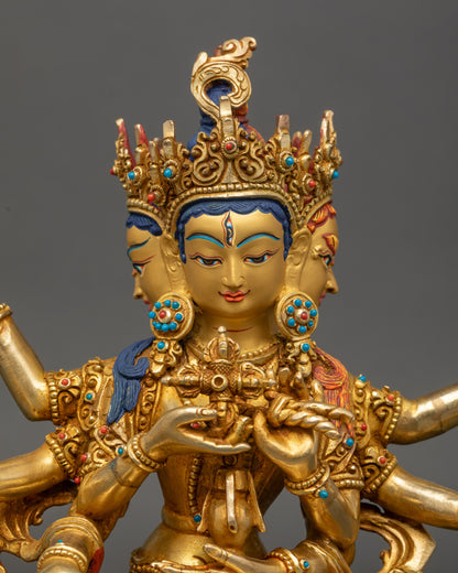 Close-up of Ushnishavijaya statue showing three faces, eight arms, and sacred implements