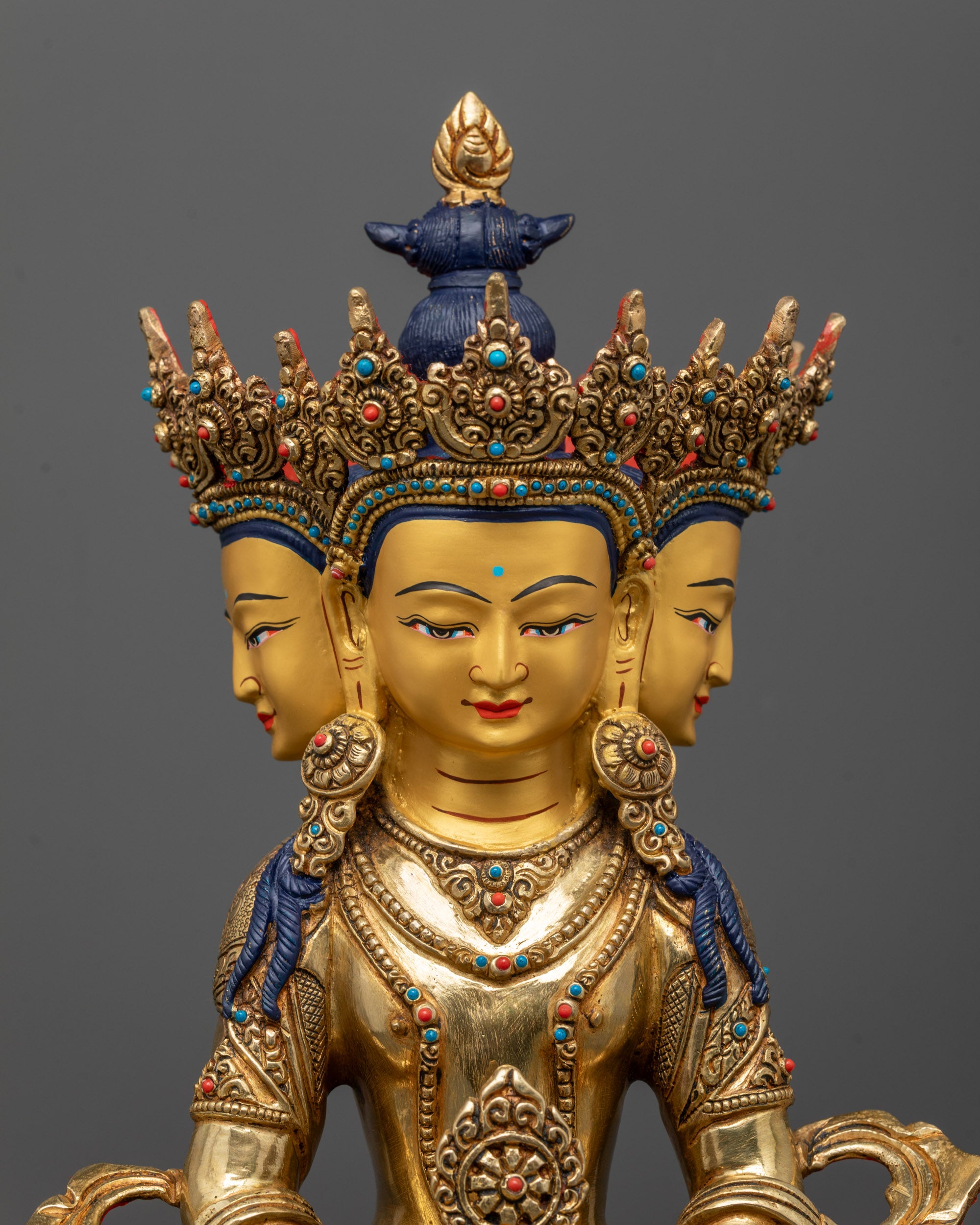 Close-up of Vairocana Buddha Statue showing three heads, five-jewel crown