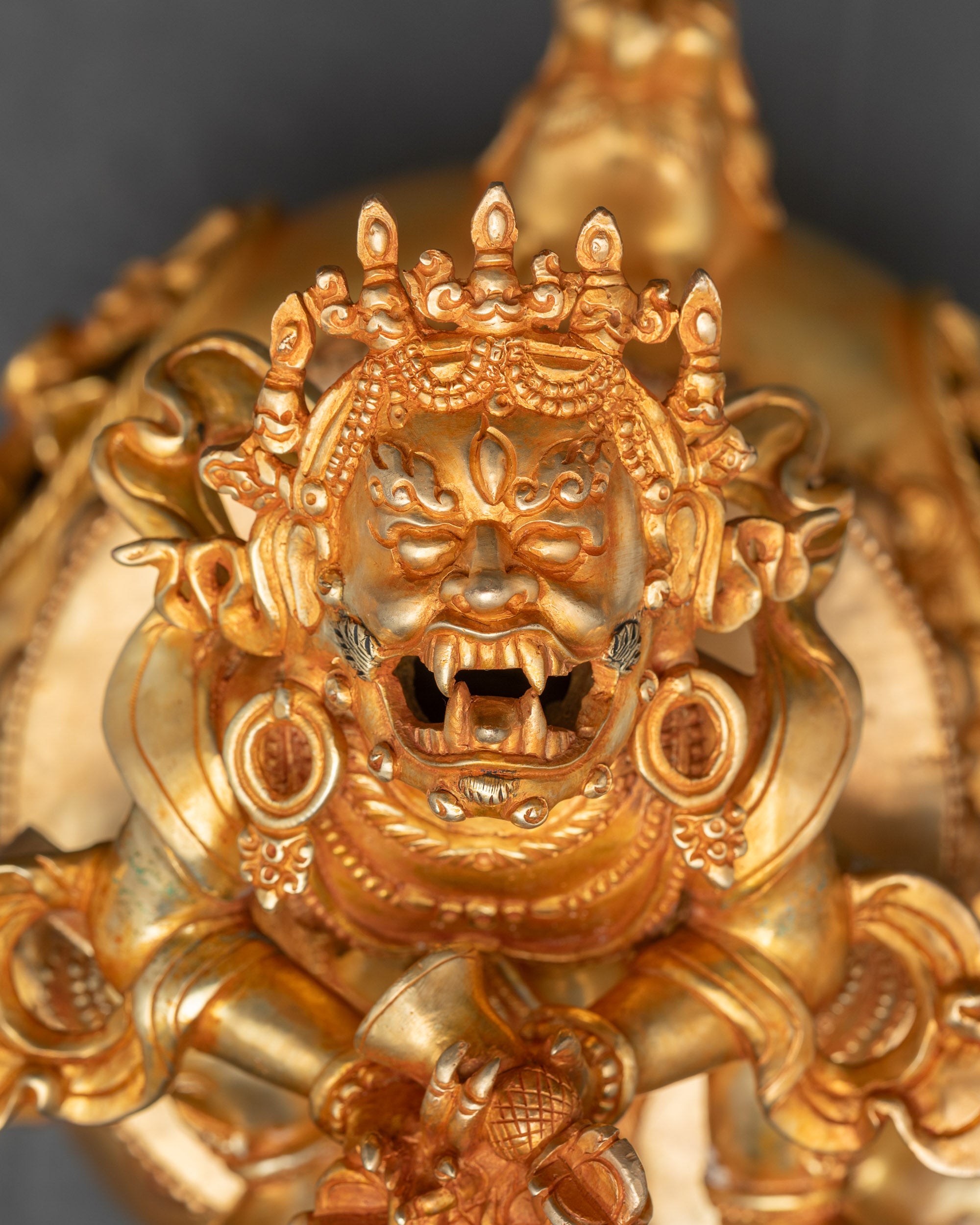 Close-up of Vajradhaka Buddha face showing fangs and fierce protective expression