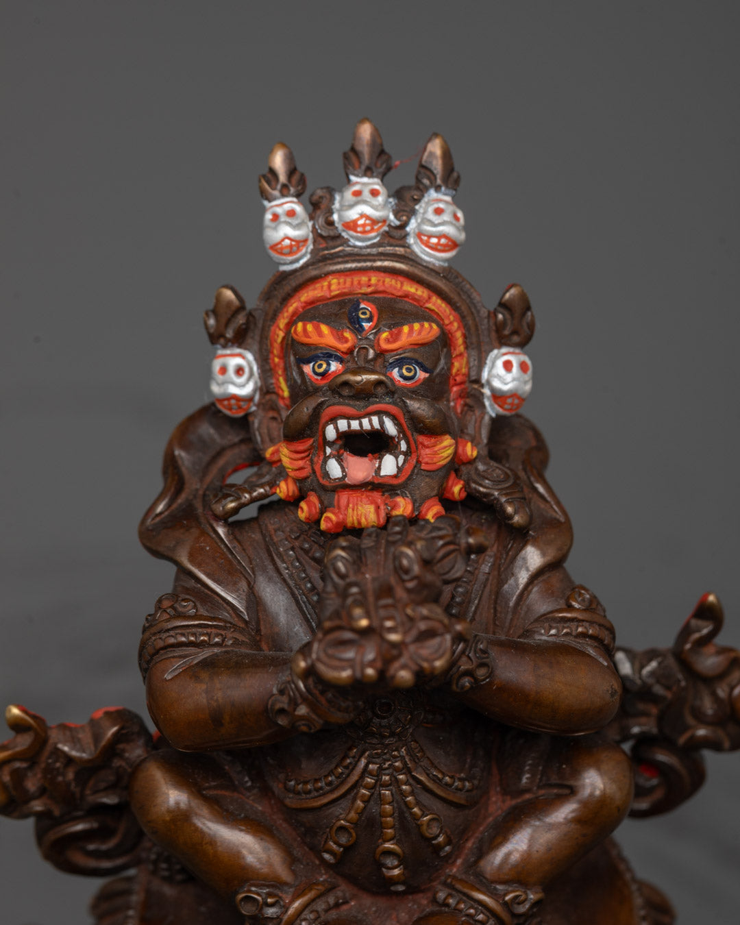 Close-up of Vajradhaka face showing wrathful expression and detailed hand-painted finish