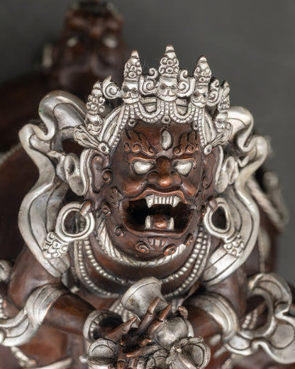 Close-up of Vajradhaka statue showing wrathful expression and fangs for spiritual empowerment