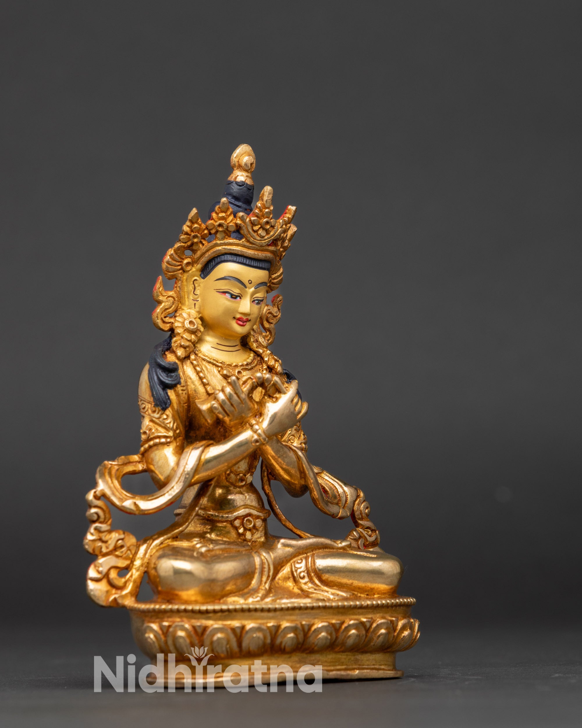 Close-up of Vajradhara Buddha face, 24k gold-painted and detailed Newari craftsmanship