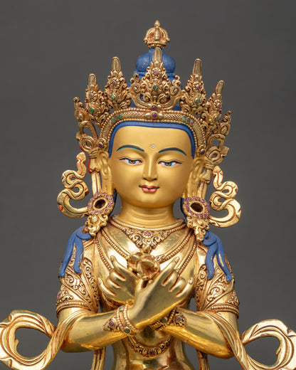 Close-up of Vajradhara Statue showing serene gold face and intricately carved robes