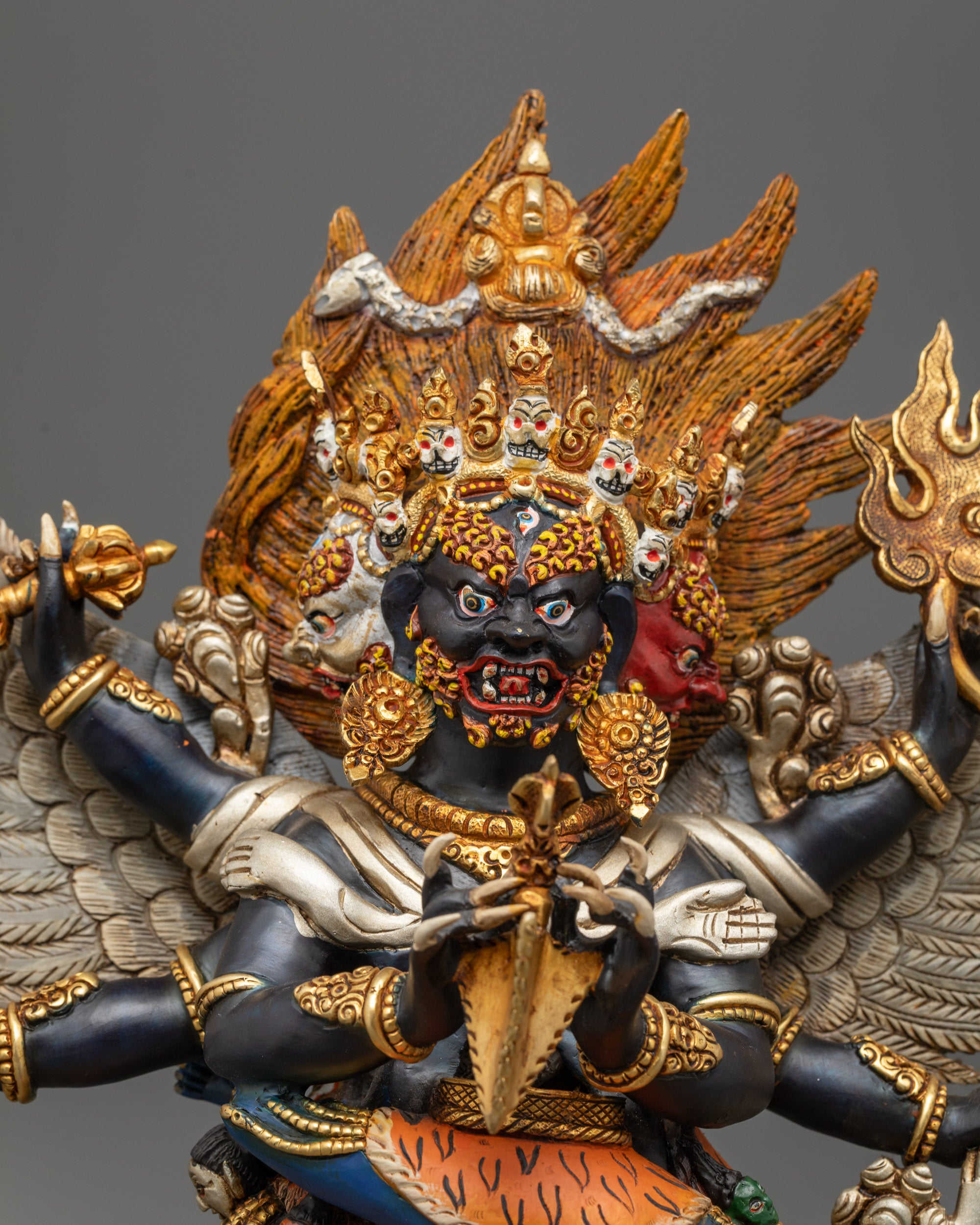 Close-up of Vajrakilaya’s black-hued body and Diptacakra partner with jewelry details