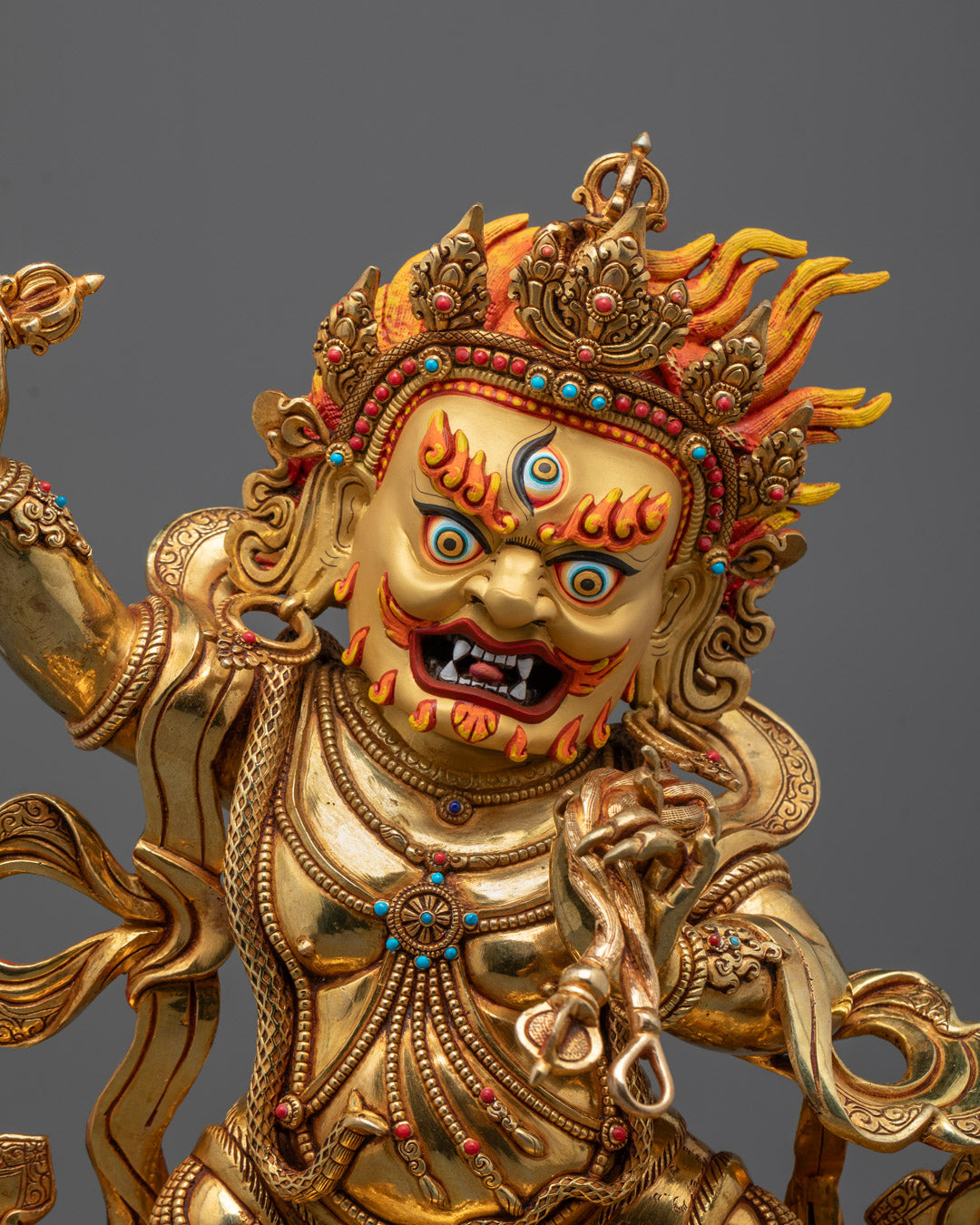 Close-up of Vajrapani holding vajra with fierce expression