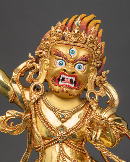 Close-up of Vajrapani sculpture showing wrathful face and golden details