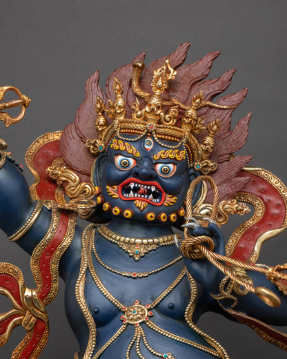 Close-up of Vajrapani statue showing detailed robes, ornaments, and vibrant gilded finish