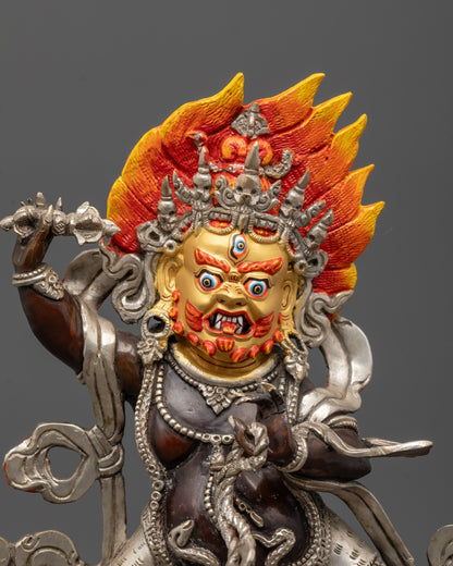 Close-up of Vajrapani statue showing wrathful face, five-skull crown and serpent details
