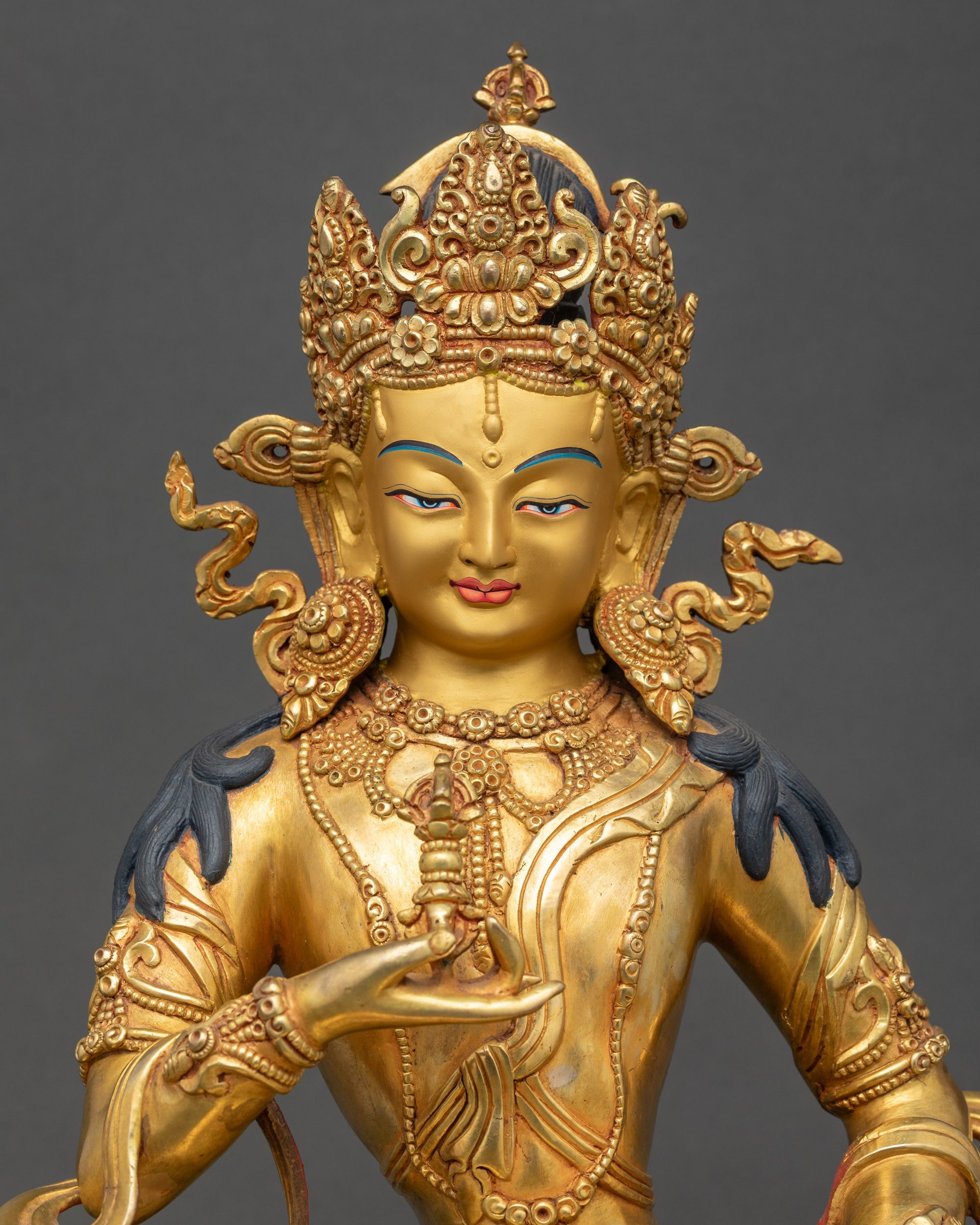 Close-up of Vajrasattva face, serene expression with gold-painted details
