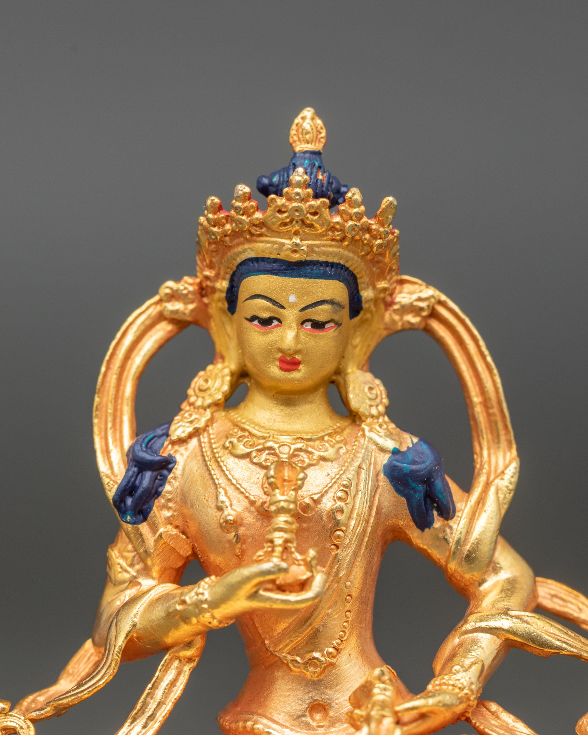 Close-up of Vajrasattva holding vajra and bell, handcrafted Nepalese spiritual art
