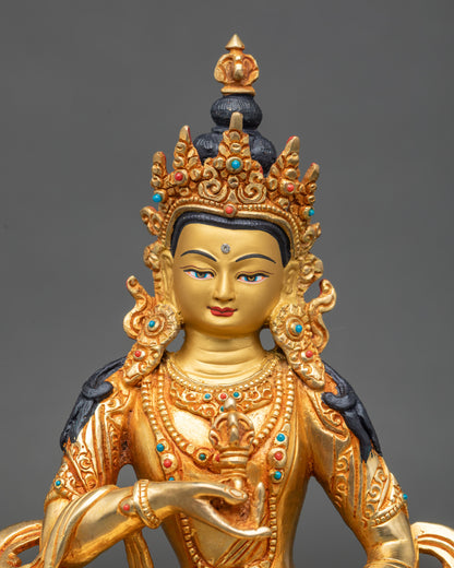 Close-up of Vajrasattva holding vajra and bell, seated on lotus seat, copper sculpture
