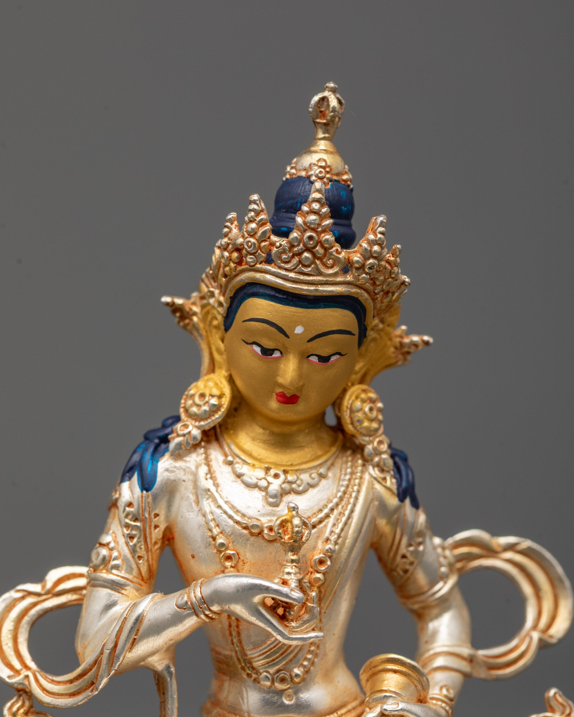 Close-up of Vajrasattva’s gold face, five-jeweled crown, and serene expression