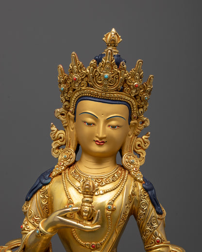 Close-up of Vajrasattva’s meditative face holding vajra and bell symbols