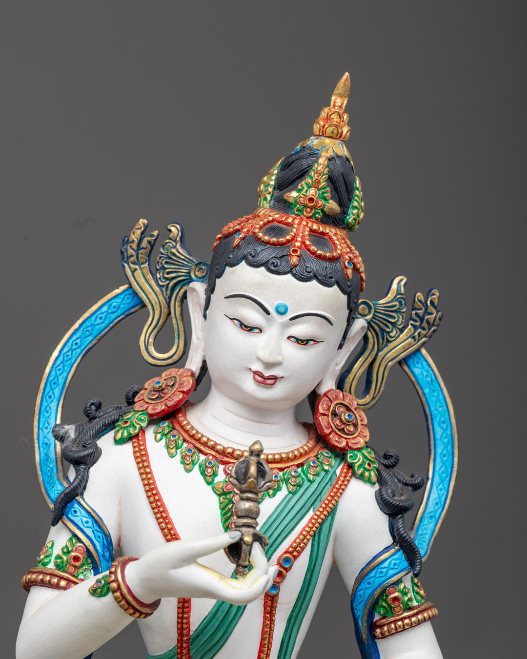 Vajrasattva’s serene 24K gold-coated face, symbolizing purity and inner peace, hand-carved from premium copper.