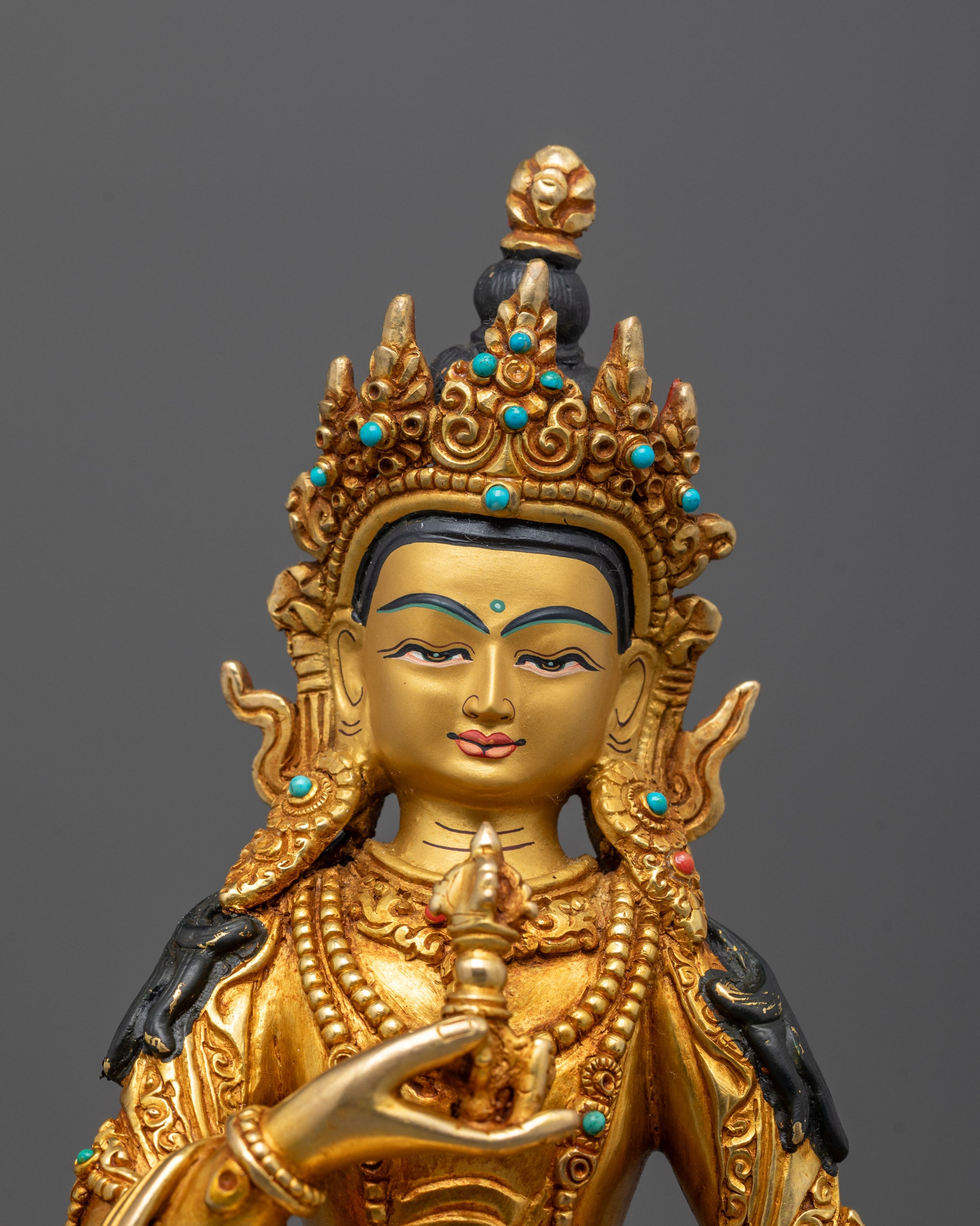 Close-up of Vajrasattva’s tranquil face and ornate crown, showcasing masterful lost-wax artistry