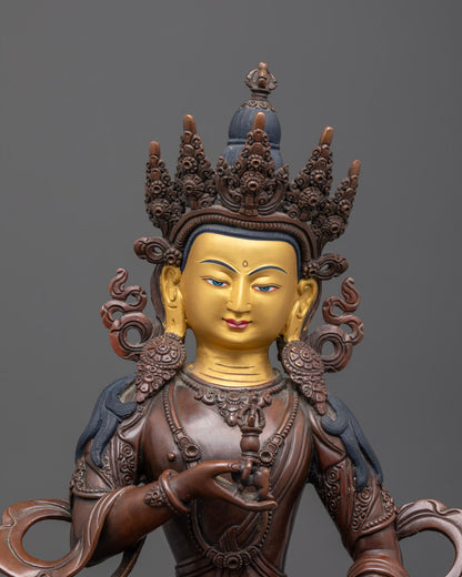 Close-up of Vajrasattva statue’s detailed oxidized copper body with gold gilding and intricate craftsmanship.