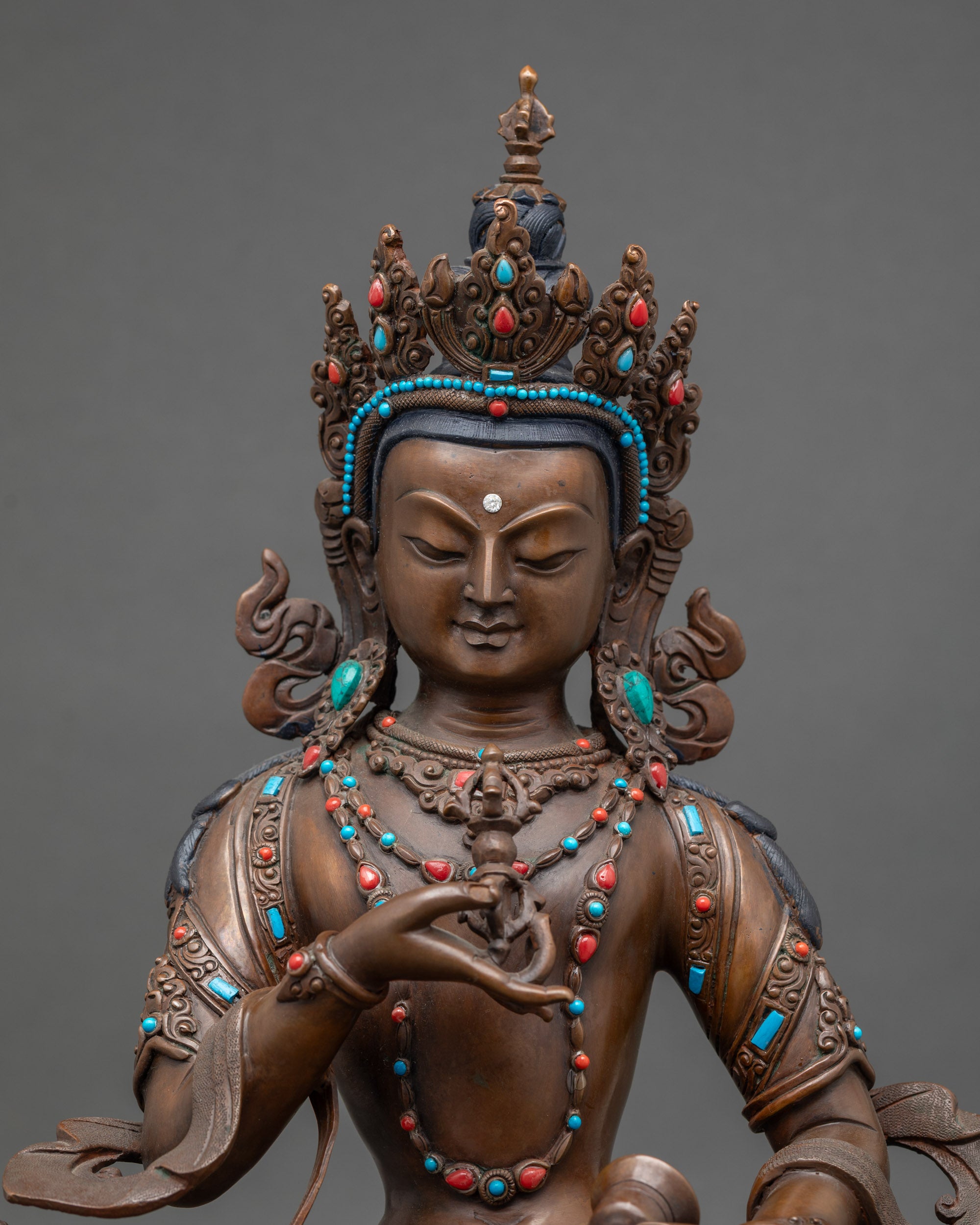 Close-up of Vajrasattva statue showing intricate semi-precious stone details