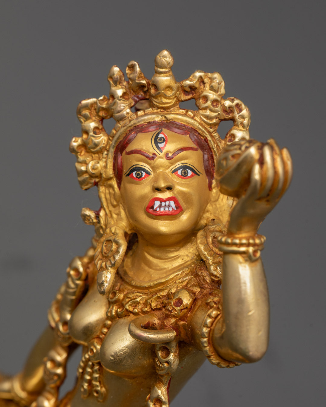 Close-up of Vajrayogini face with detailed crown and flame-like halo
