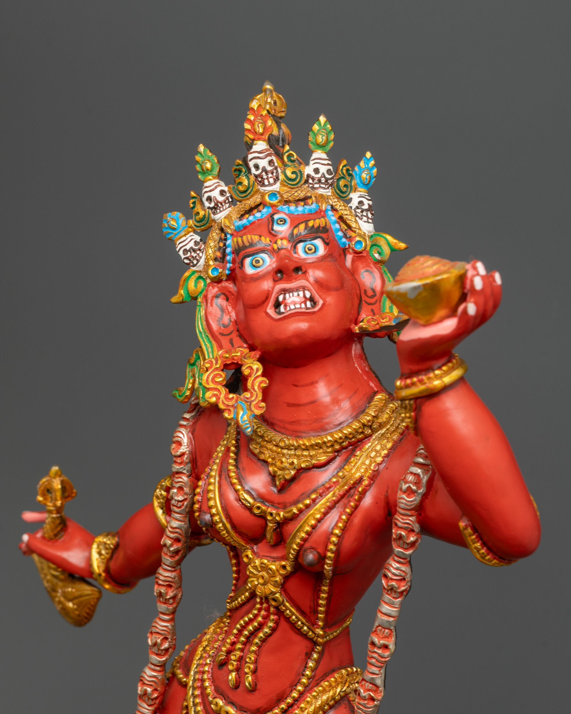 Close-up of Vajrayogini holding vajra and skull cup with five-skull crown