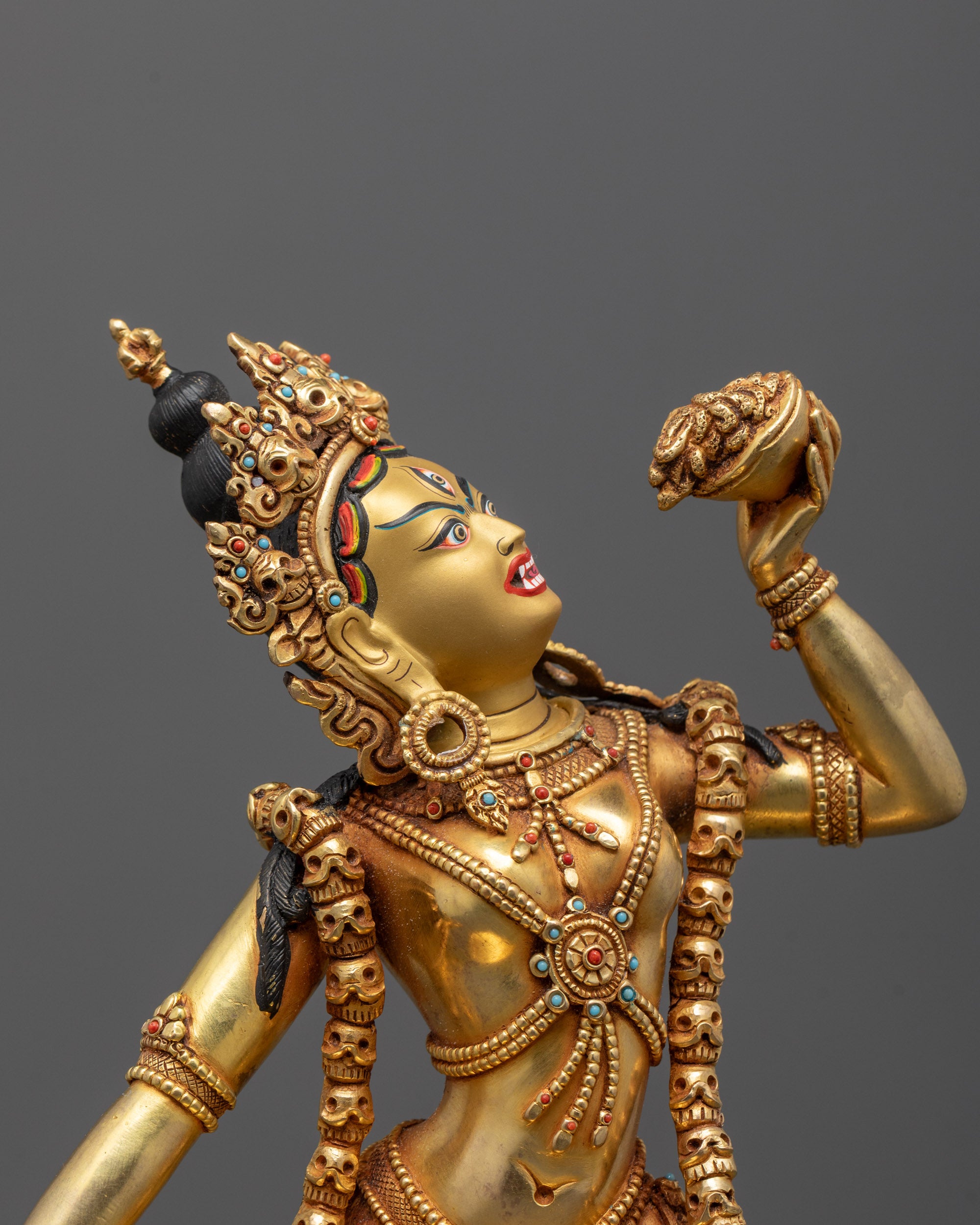 Close-up of Vajrayogini's expressive face and symbolic ritual implements