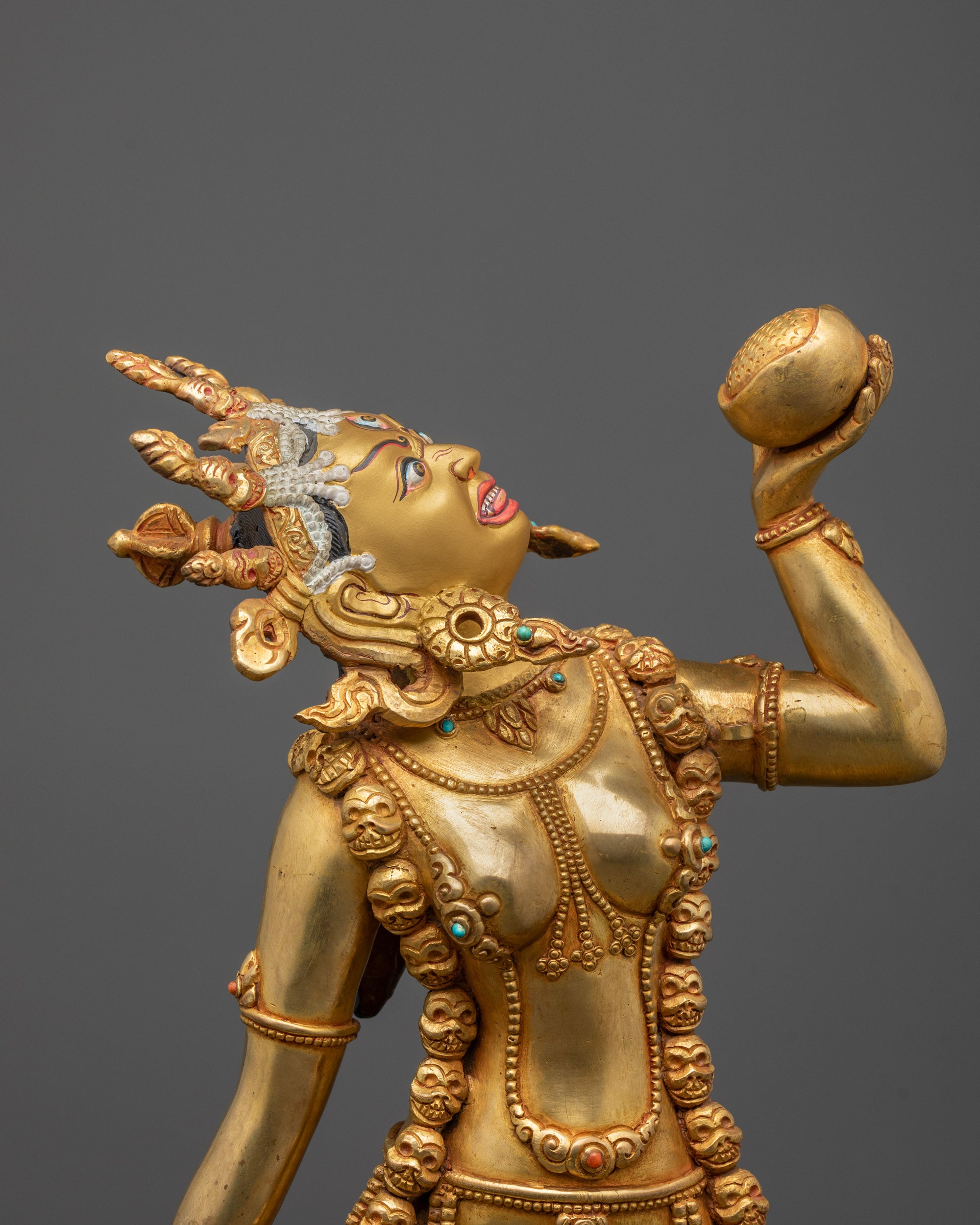 Close-up of Vajrayogini’s fierce expression and gold-gilded face symbolizing enlightened