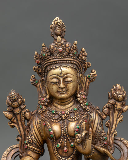 Close-up of White Tara statue showing intricate lotus pedestal and oxidized details