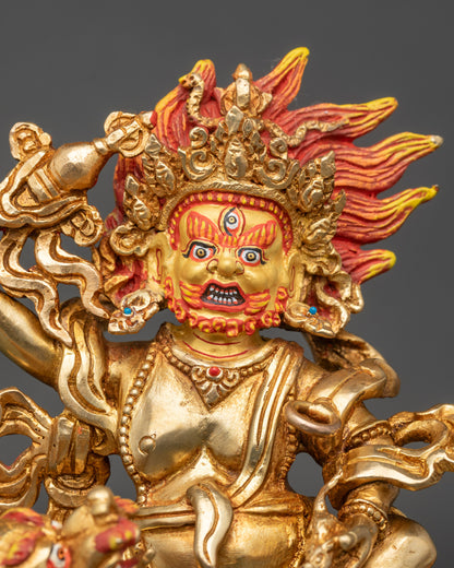 Close-up of White Dzambhala’s gold-painted face with intricate acrylic details