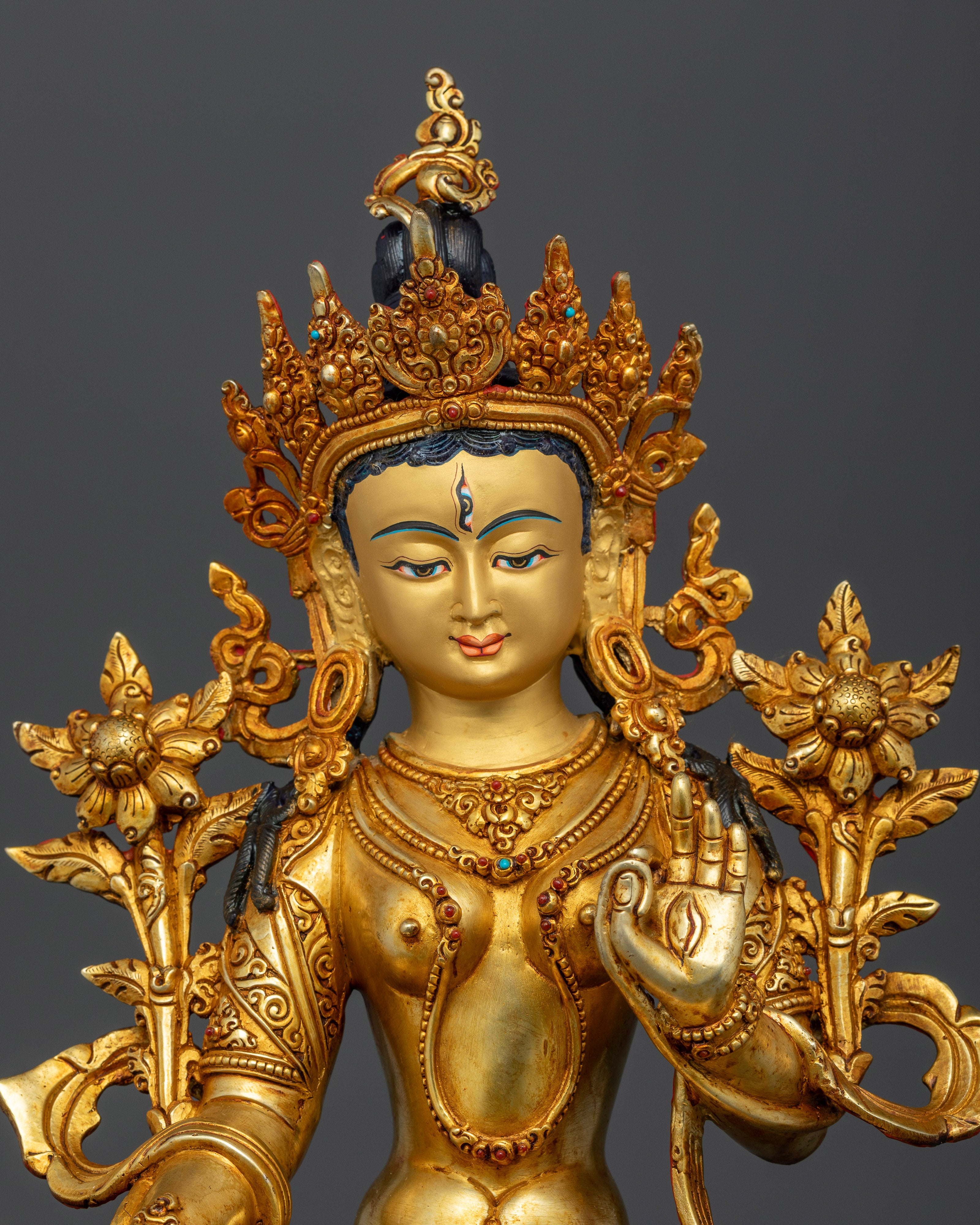 Close-up of White Tara Bodhisattva, gold fire-gilded face and lotus flower details