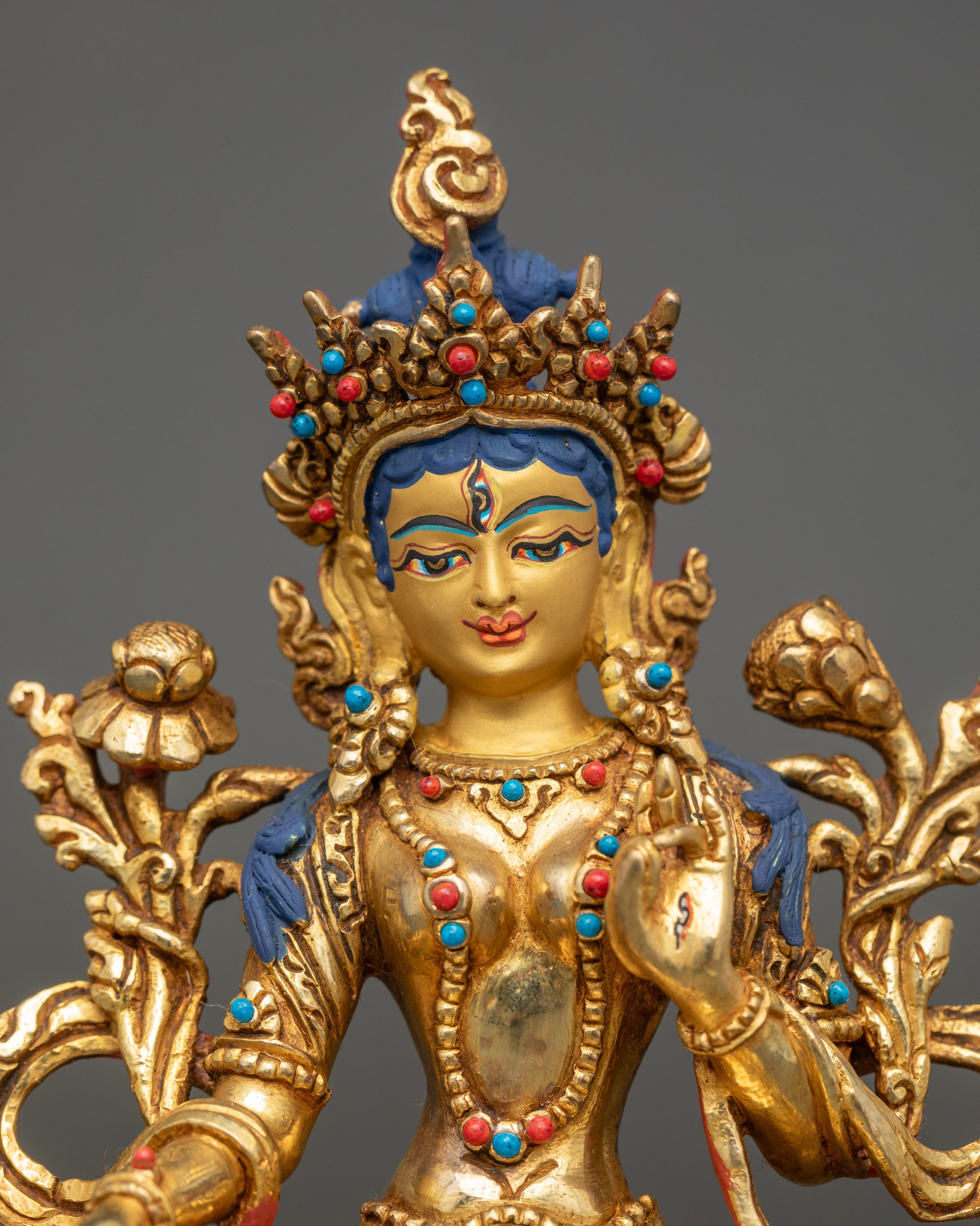 Close-up of White Tara Buddha Statue showing intricate five-jeweled crown and robe