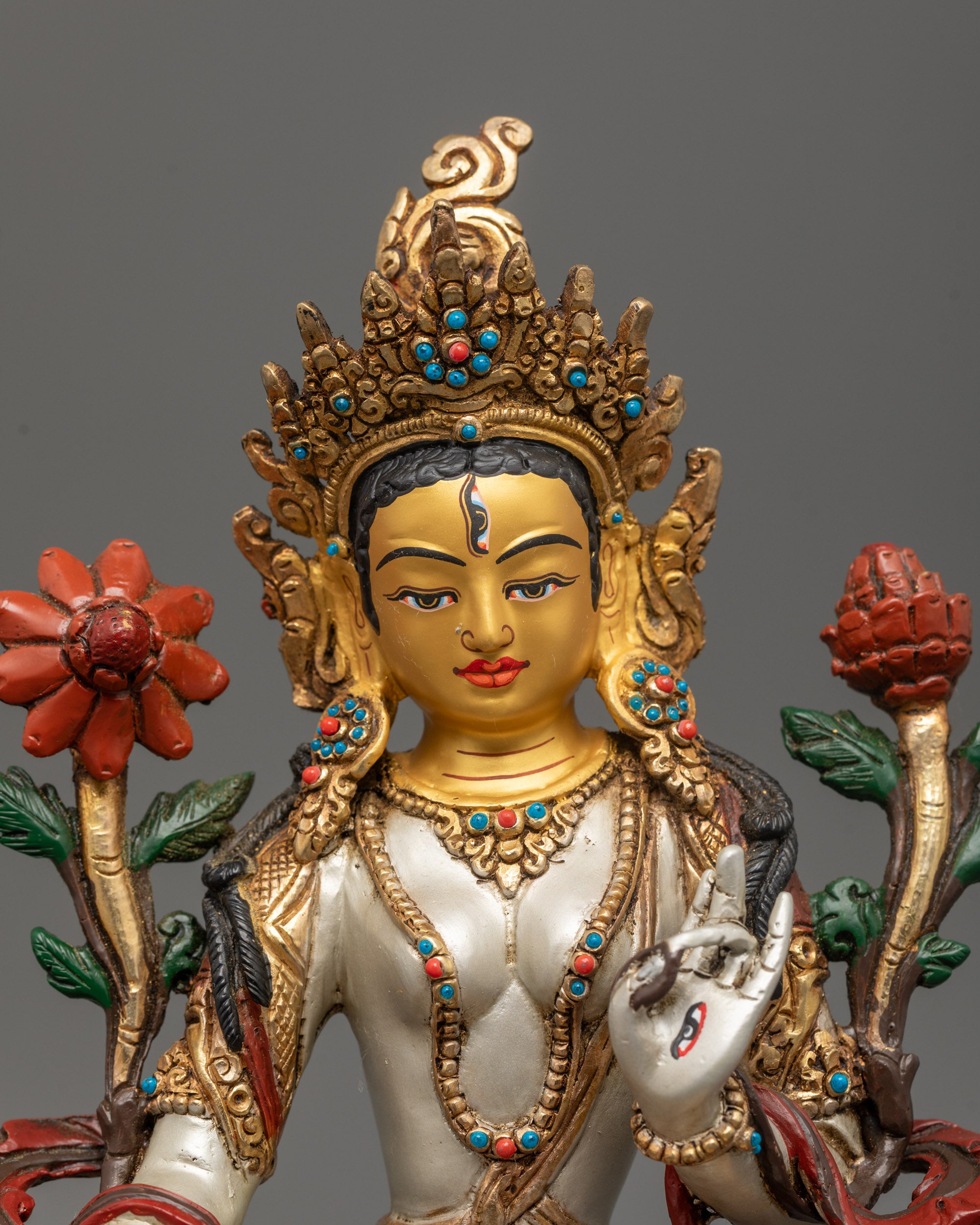 Close-up of White Tara Statue face – 24k gold-gilded face