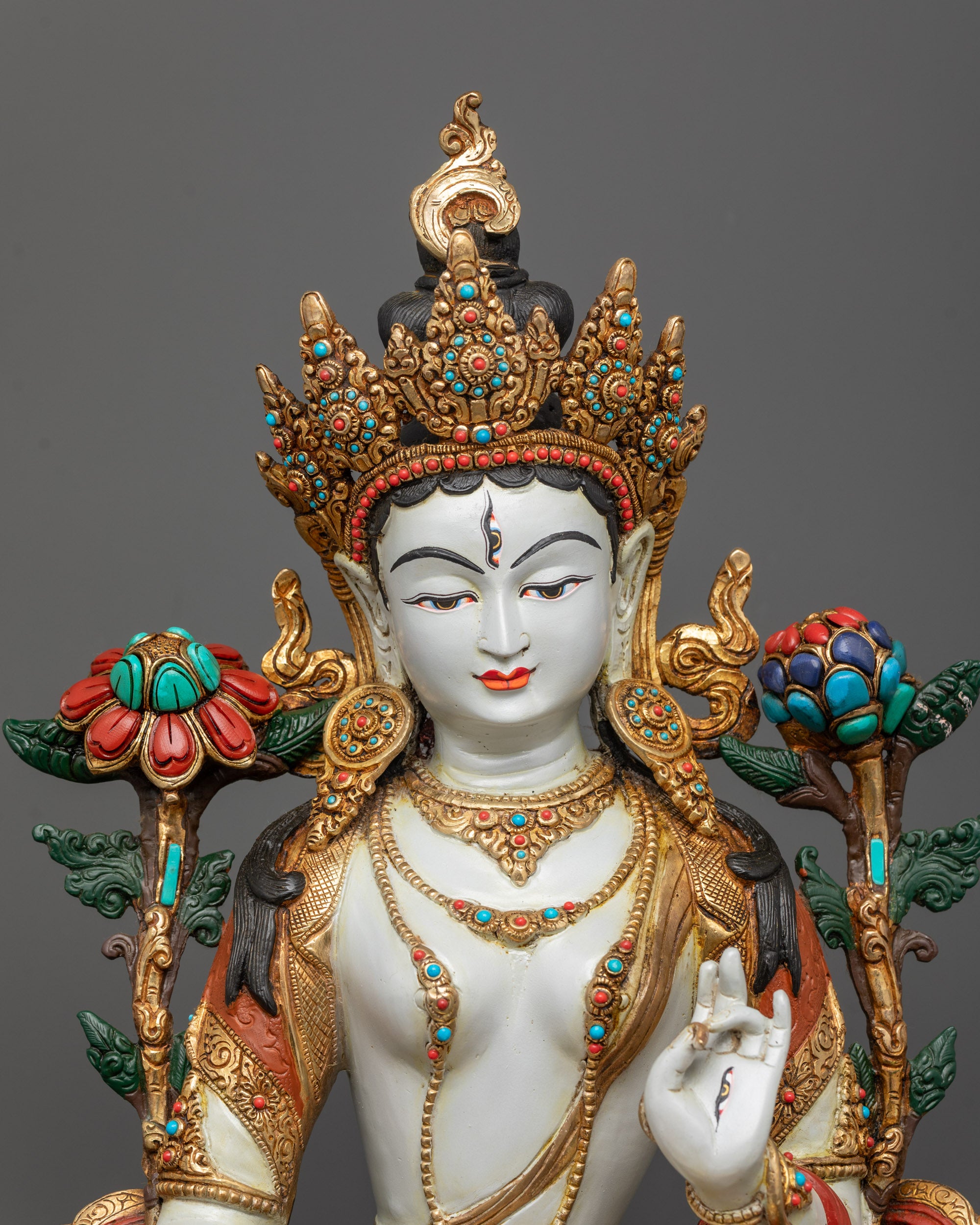 Close-up of White Tara Statue highlighting semi-precious stones and five-jewel crown