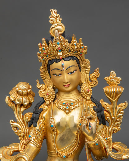 Close-up of White Tara face with gold painted features and serene expression
